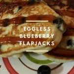 Flapjacks with fresh blueberries served on a colored plate