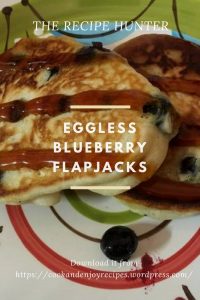 Flapjacks with fresh blueberries served on a colored plate