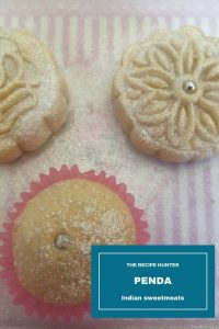 Balls of dough baked in small paper cup holders and decorated with small silver ball in the center as well as a beautifully shaped and pressed out cookie, dusted with silver powder and decorated with a silver ball