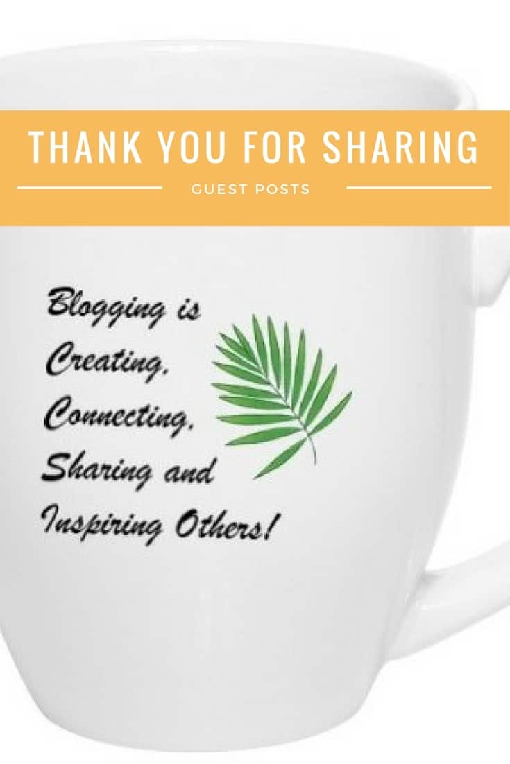 A white mug with blogging is creating, connecting sharing and inspiring others printed in cursive on the front with a green leaf next to the writing