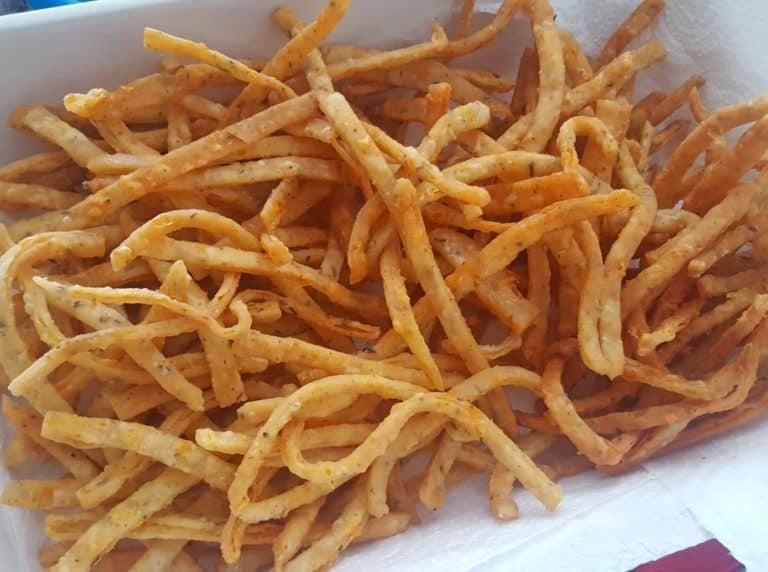 Finely cut Cheese Straws in a white bowl