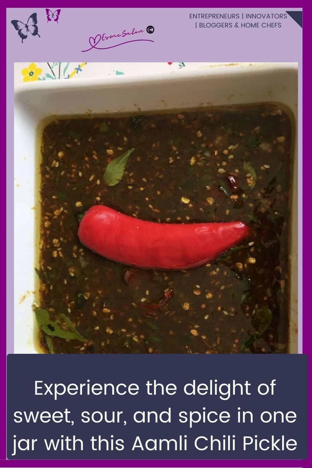 an image of a square white dish filled with Sweet And Sour Ground Aamli Chili Pickle (Tamarind) and a red chili as decoration