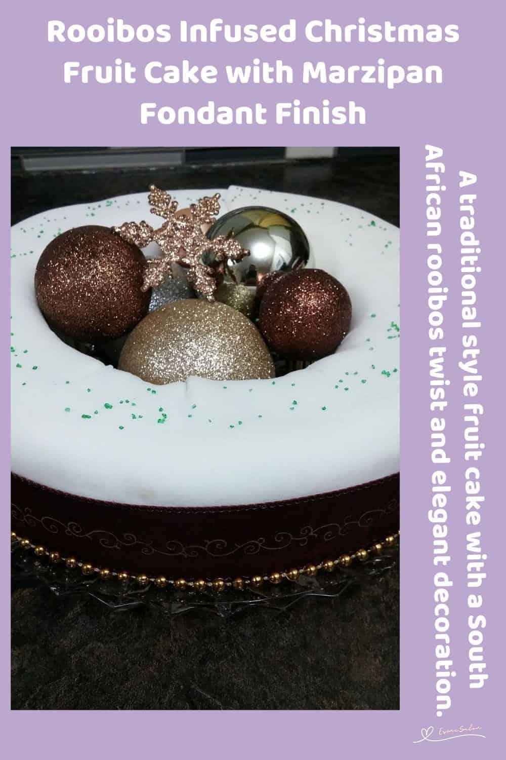 An image of a Rooibos Infused Christmas Fruit Cake covered with white marzipan and decorated with Christmas balls and starts