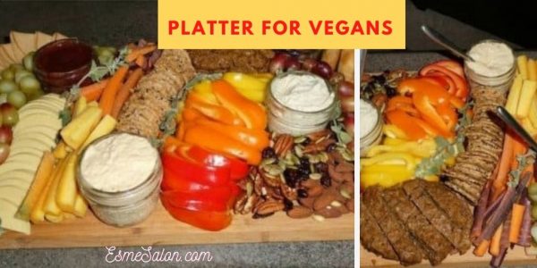 Vegan cheese platter, with nuts, bread, dips, veggie sticks, olives, red, yellow and orange peppers