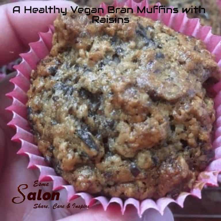 A Vegan Bran Muffins with Raisins in a pink plastic cupcake liner