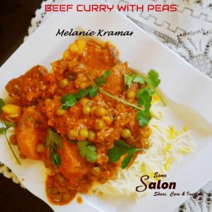 A white square plate with Beef Curry with Peas, and chopped coriander