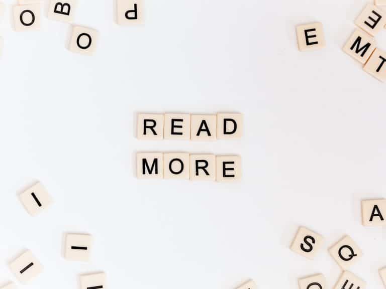 Scrabble blocks with words "read more"
