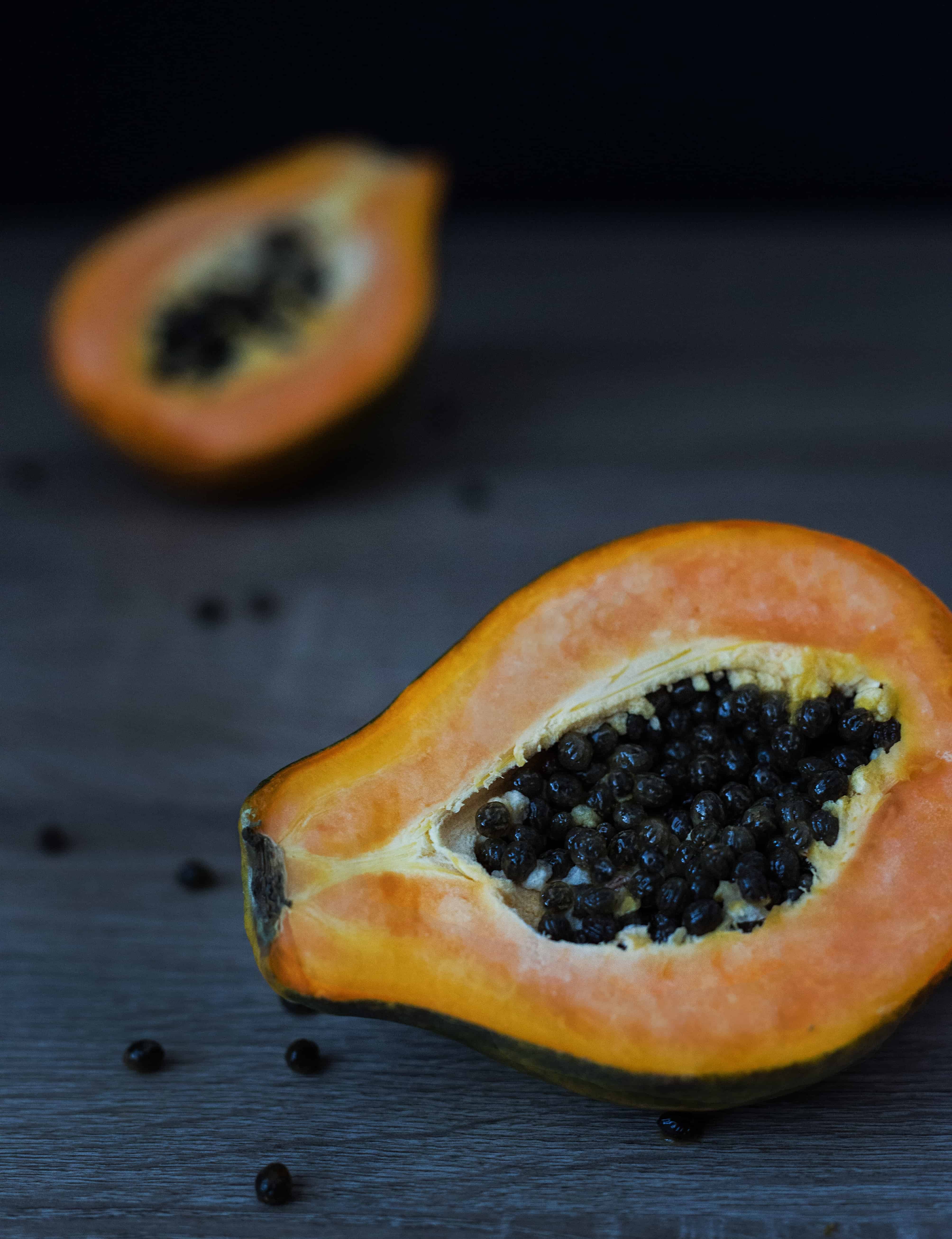 Half a slice papaya fruit with pips