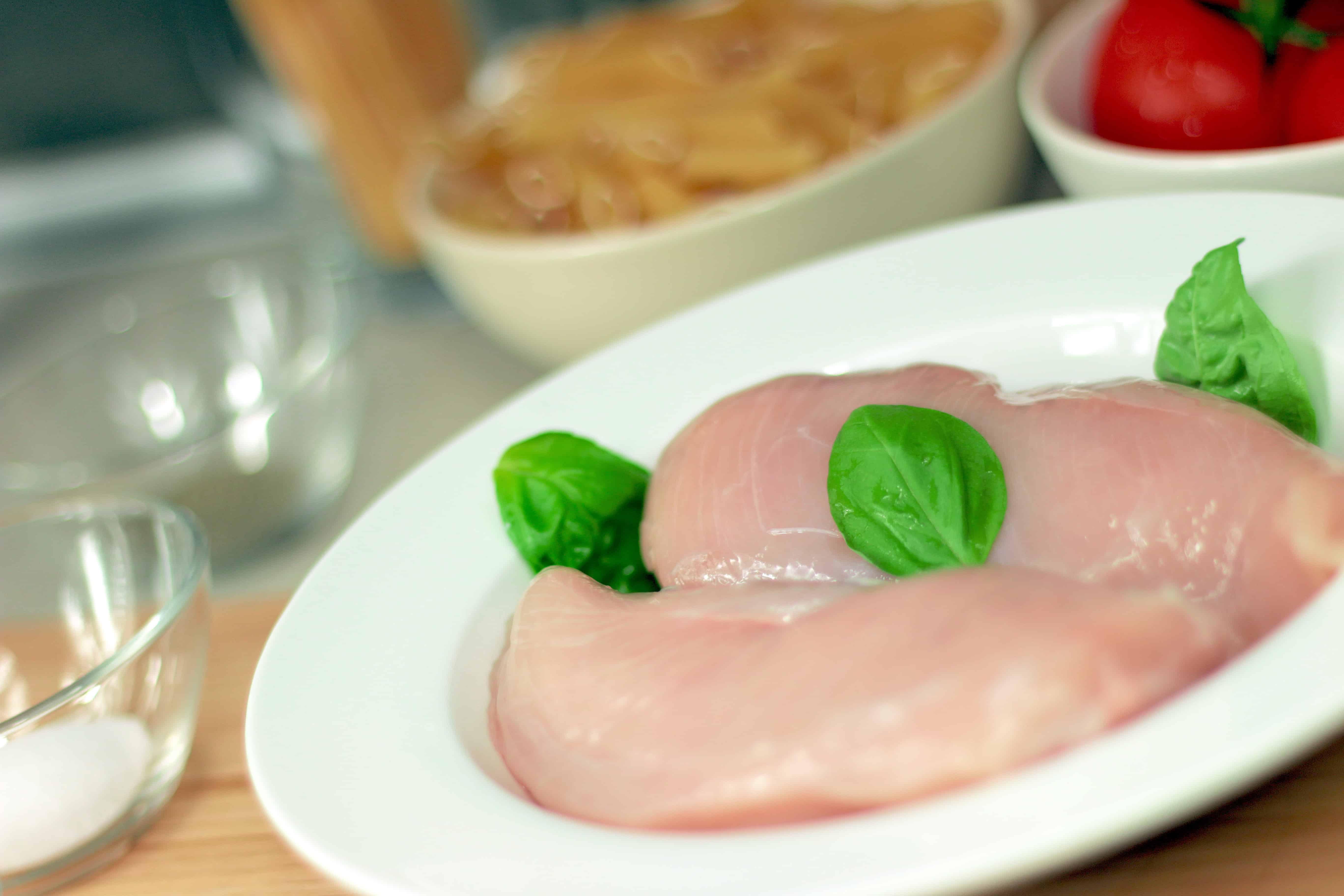 Raw pieces of chicken in a white plate