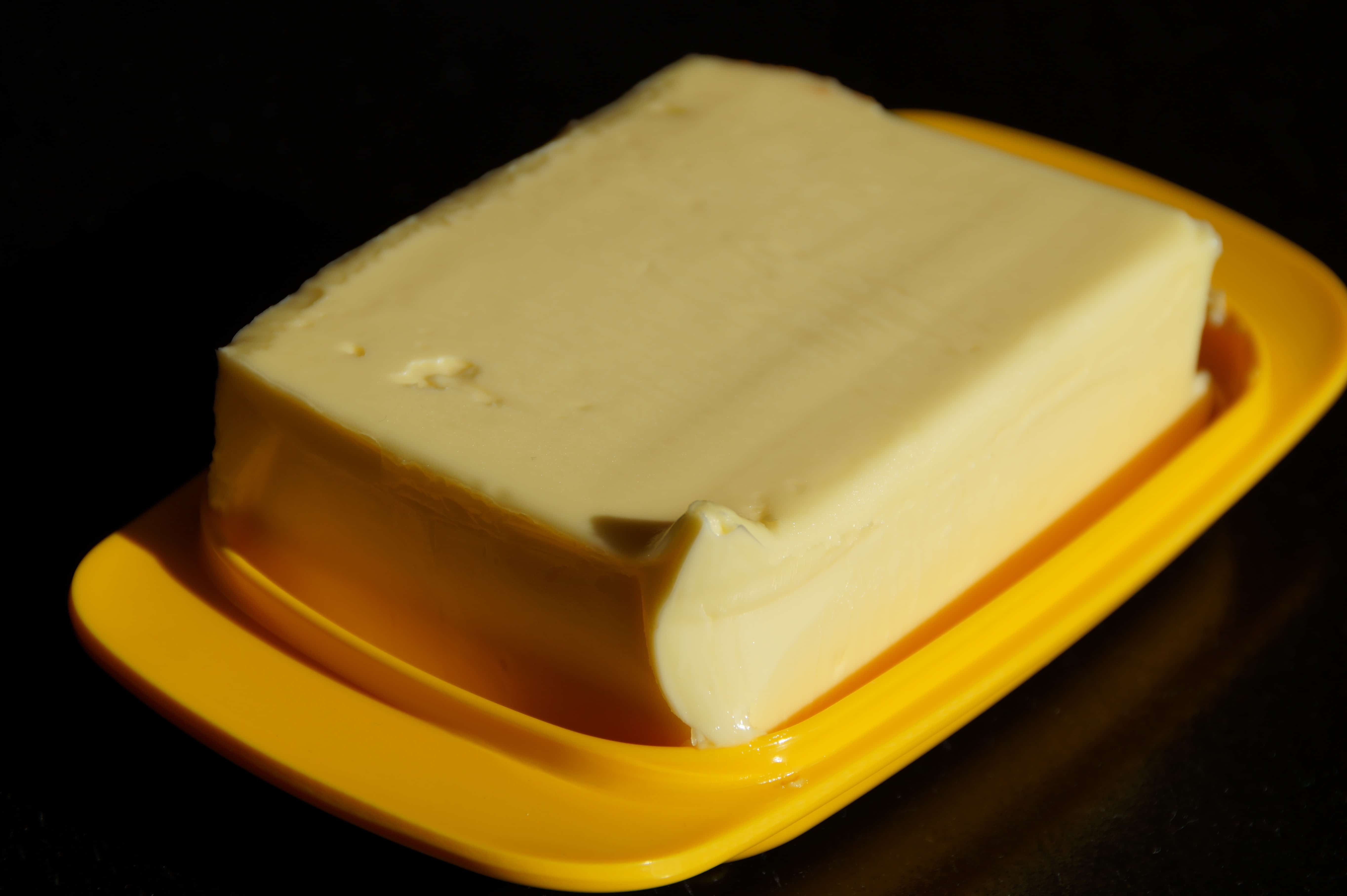 Block of butter on orange dish