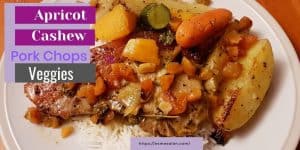 slices of pork with potatoes, carrots, onion and cashews