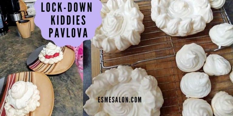 Pavlova on wooden table and also served with some fruit and chantilly cream