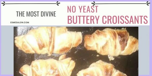 4 baked Croissants on a black baking tray