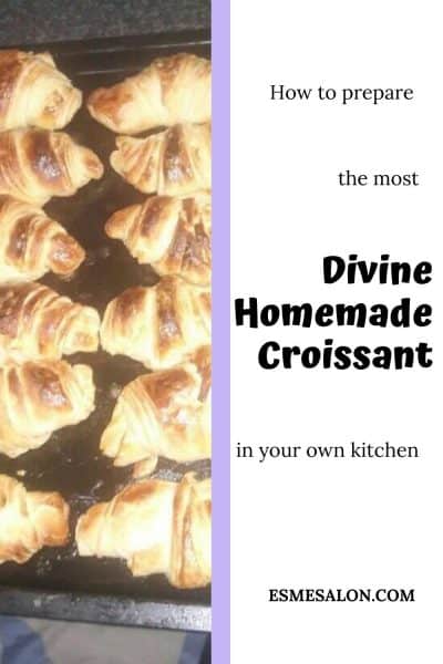 12 baked Croissants on a black baking tray