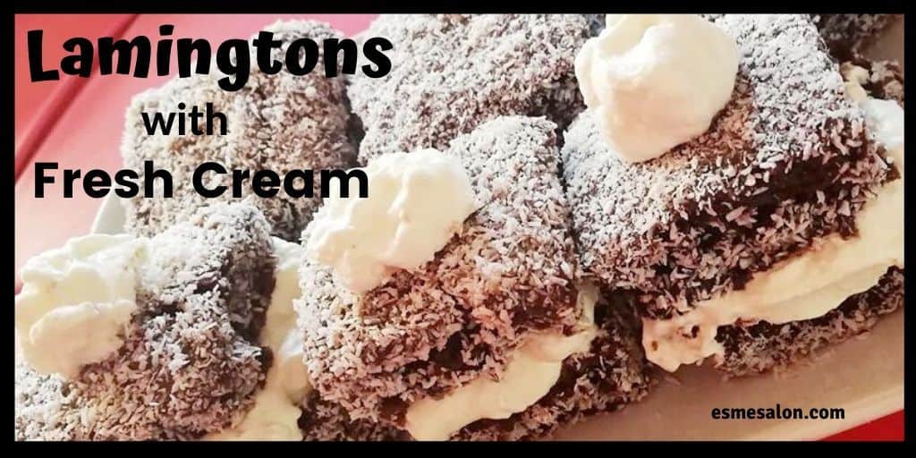 Australian Lamington. chocolate cake covered in coconut and two pieces with some fresh cream in the middle and a cream dollop on top as well