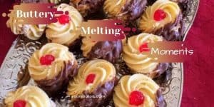 Buttery melting moment cookies dipped in chocolate and a cherry in the center