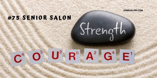 white sand with a black stone and strength written in white and playing cards with the work courage in red
