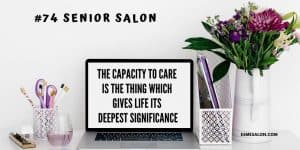 white computer screen with a white jug and purple flowers on the side with a mauve scissors and pens in a pen holder