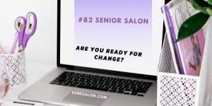 lilac scissors, pen and books next to a silver laptop with black keys and open white screen