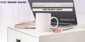 white bed pedestal, white coffee mug, pink phone and open laptop