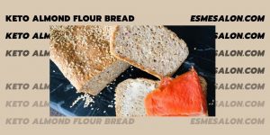 Keto Almond Flour Bread with sesame seed, sliced bread buttered and lox added on a black board with