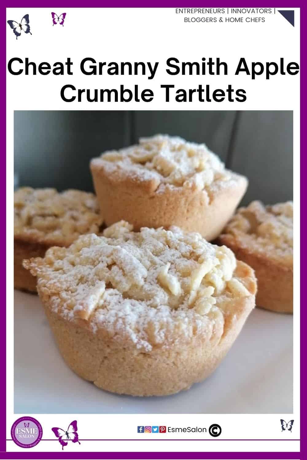 an image of small Apple Crumble Tartlets sitting on a baking tray