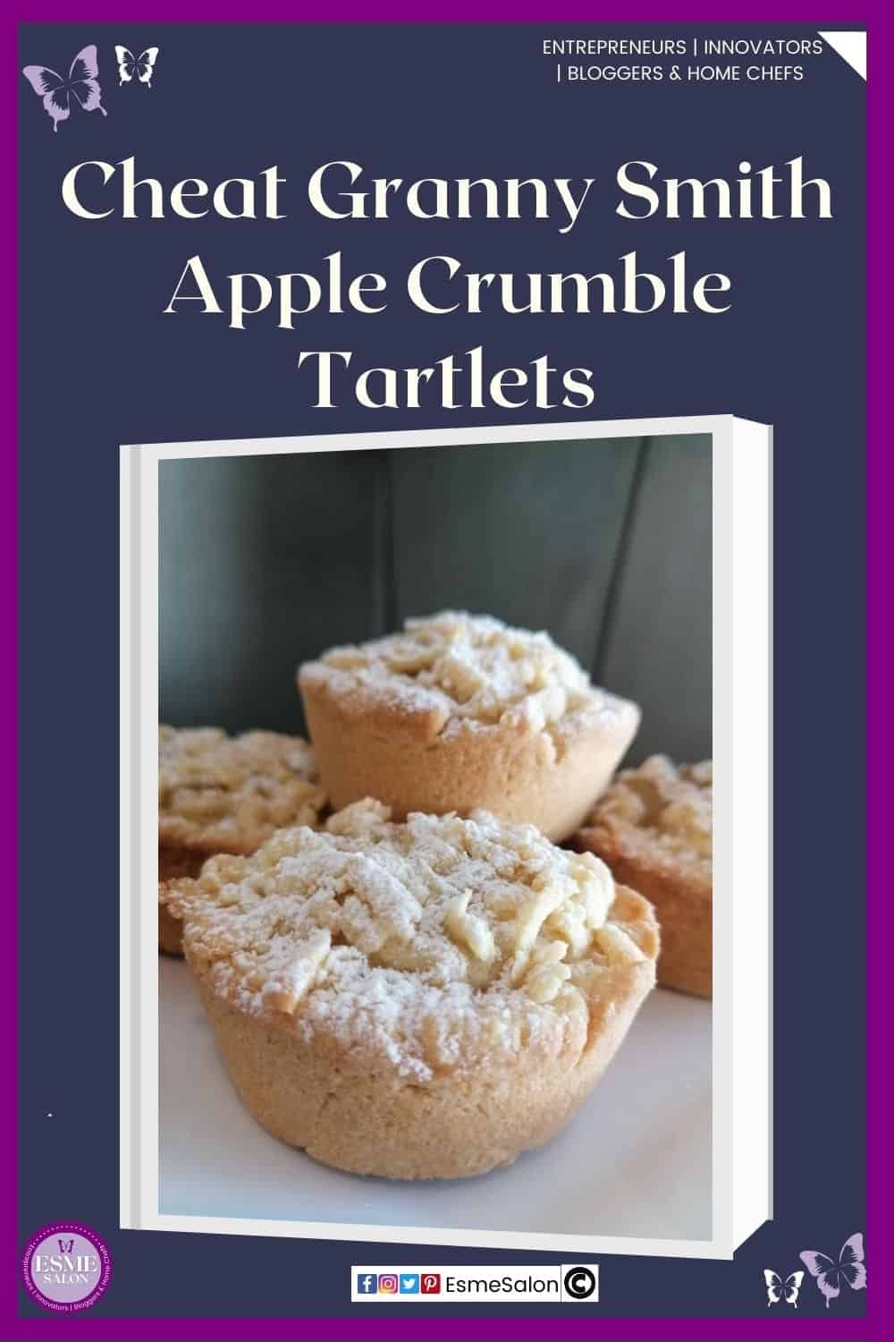 an image of small Apple Crumble Tartlets sitting on a baking tray