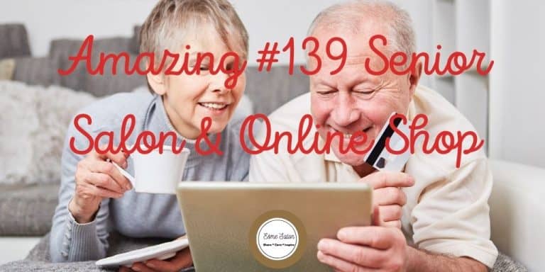 Elderly coiuple with cup of tea and credit card working on laptop