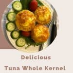 Tuna Whole Kernel Crustless Quiche in black muffin pan on a bed of spinach, sliced cucumbers and baby tomatoes