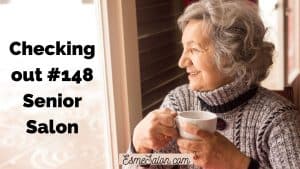 elderly lady with greyish cowl neck top and cup of tea of coffee