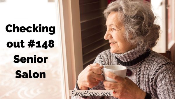 elderly lady with greyish cowl neck top and cup of tea of coffee