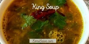 A white bowl of King Soup with red chili