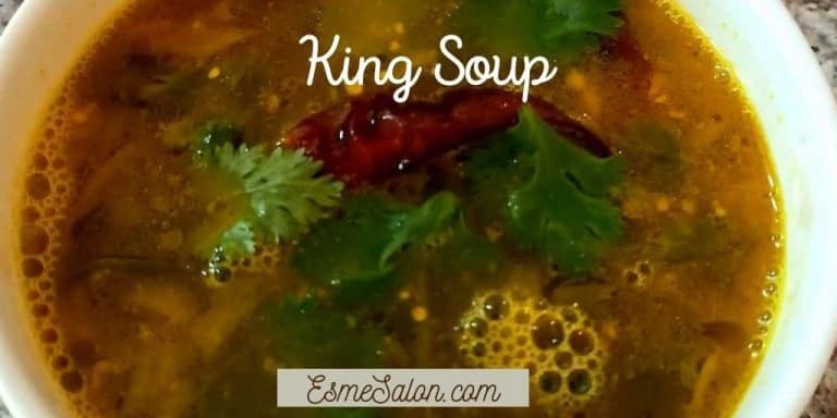 A white bowl of King Soup with red chili
