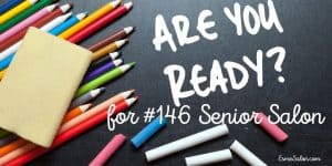 colored crayons with a yellow notepad on a black background