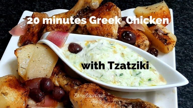 White platter with chicken pieces, olives, potato and Tzatziki