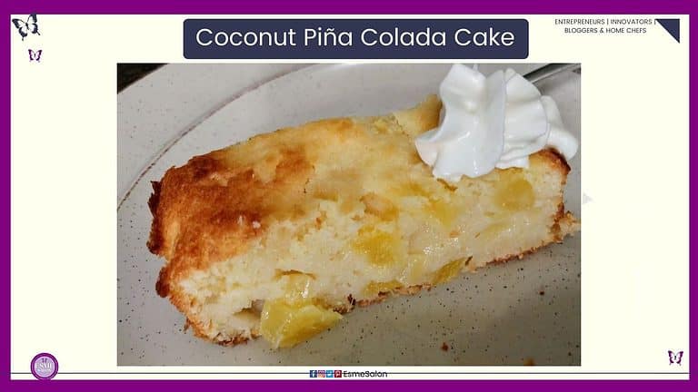 an image of a slice of Coconut Piña Colada Cake oozing with pineapple and a dollop of cream on a white side plate