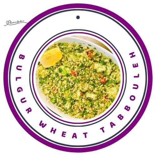 an image of a white oblong dish filled with Bulgur Wheat Tabbouleh with a sliced or lemon on the side