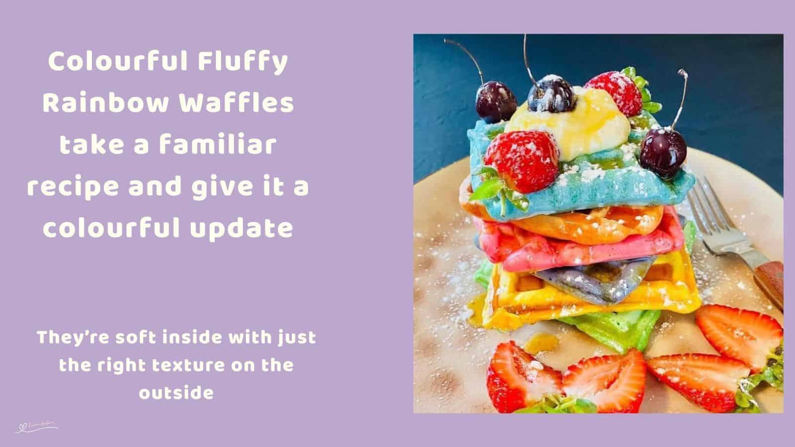 An image of a stack of colourful, fluffy, rainbow waffles with fruit and some cherries