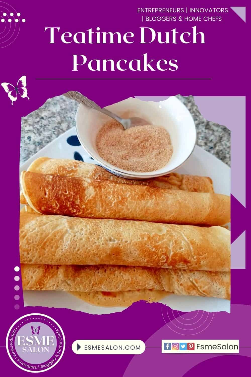 An image with a white place and 5 rolled up Teatime Dutch Pancakes with a bowl of cinnamon sugar on the side