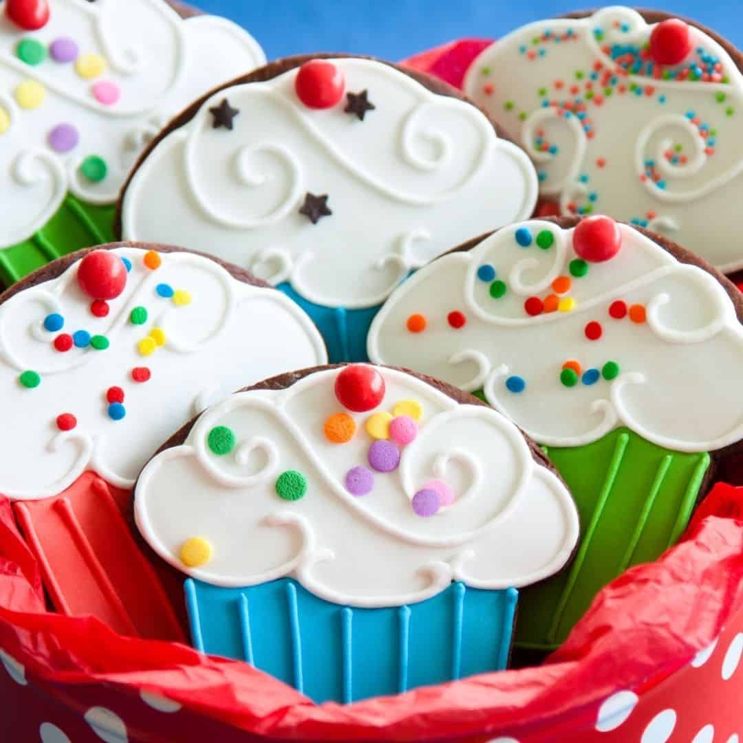 An image of cupcakes with sprinkles in a red basket