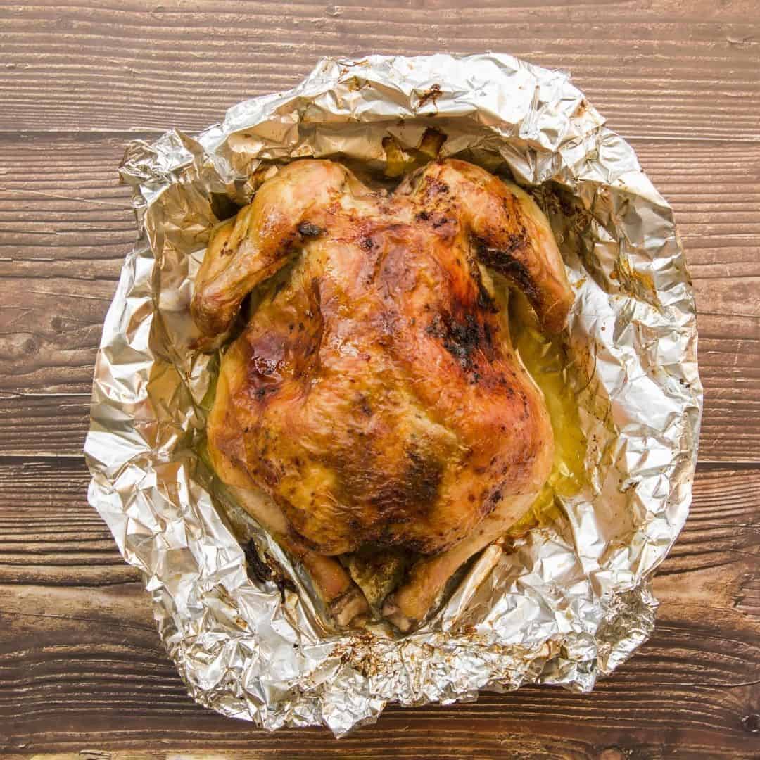 An image of a roasted chicken in tinfoil