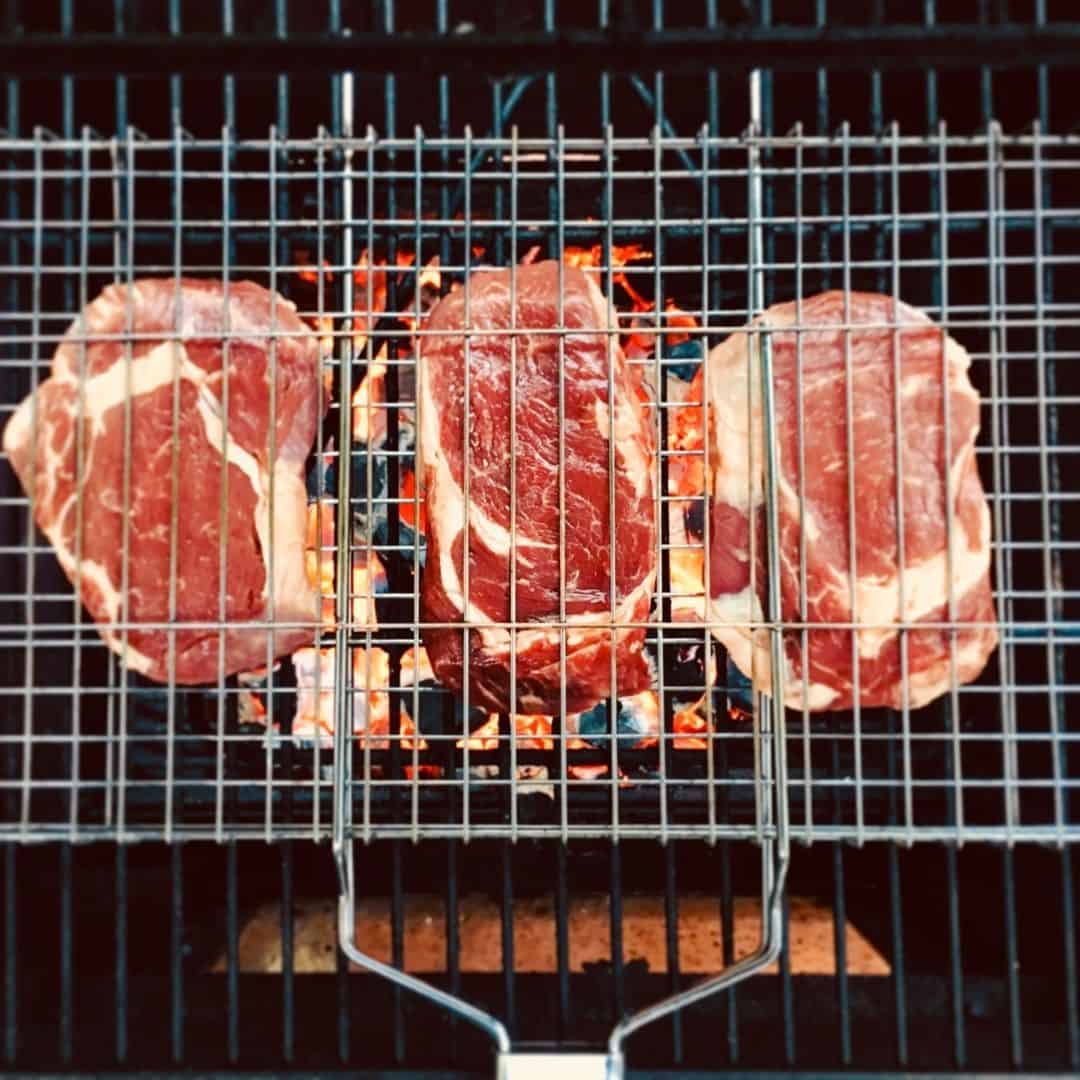 An image of 3 steaks on a BBQ grid