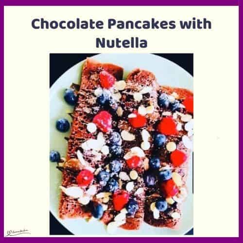an image of a white plate with 4 Chocolate Pancakes with Nutella and berries