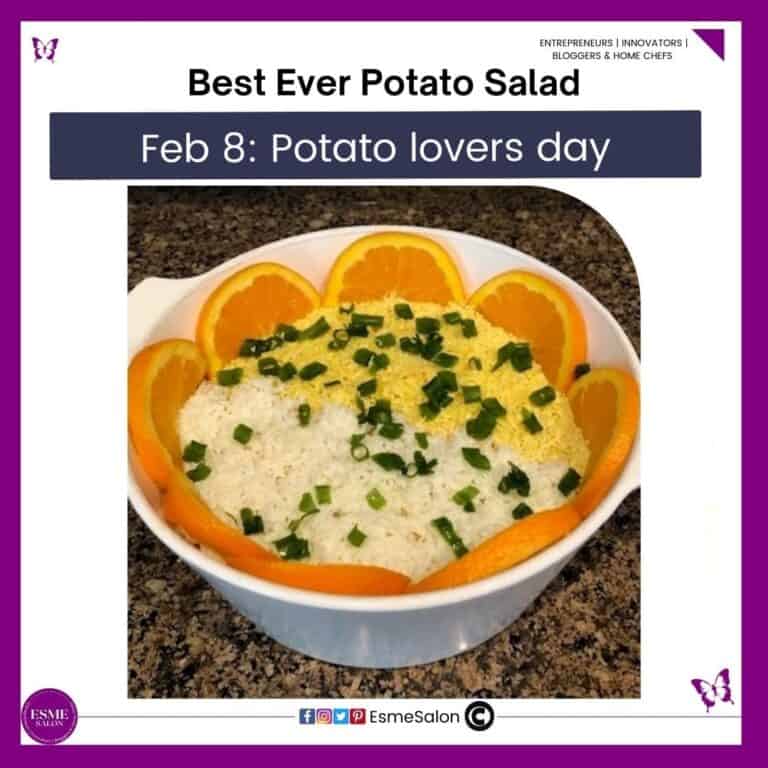 an image of a deep white bowl filled with Potato Salad and slices or orange around the rim of the bowl with grated egg and chopped chives