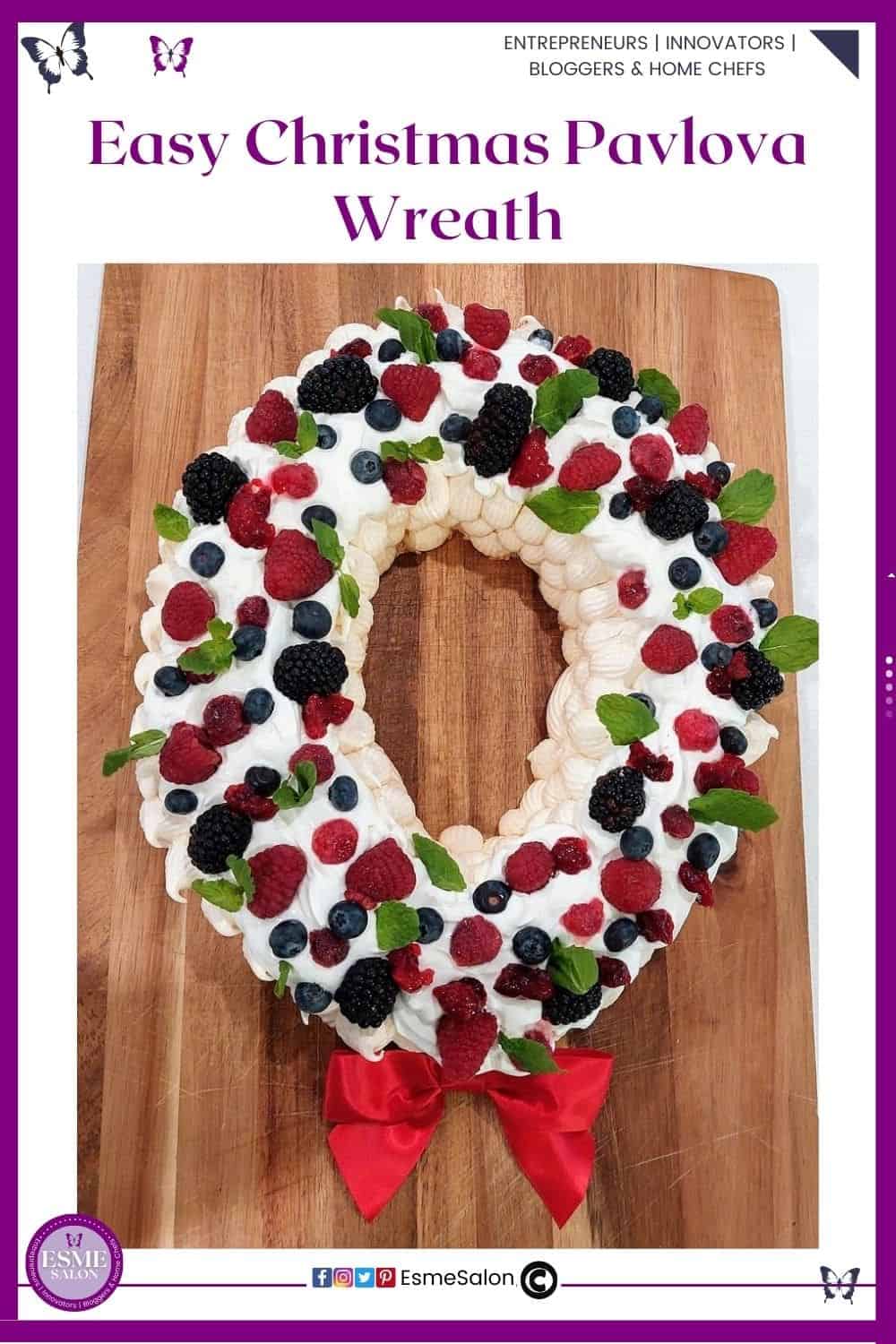 an image of a round Christmas Pavlova Wreath with lots of fruit, mint leaves and a red bow red at the bottom