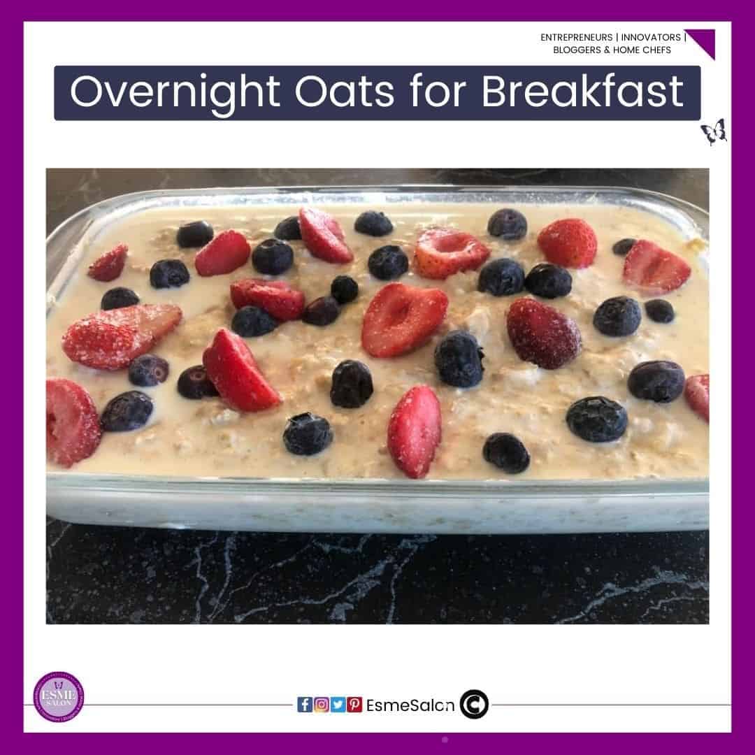 an image of Overnight Oats for Breakfast in a rectangular glass dish and topped with strawberries and black/blueberries