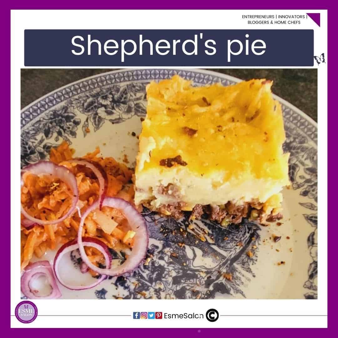 an image of a blue Delft plate with a block of Shepherd's Pie and a side of salad