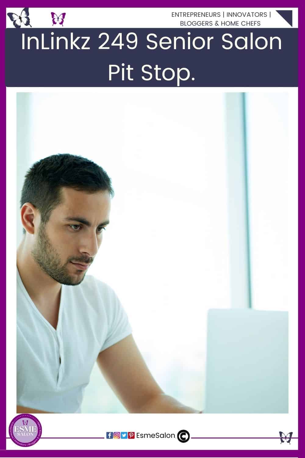 An image of a dark hair man with a white v-neck shirt sitting and working on his computer