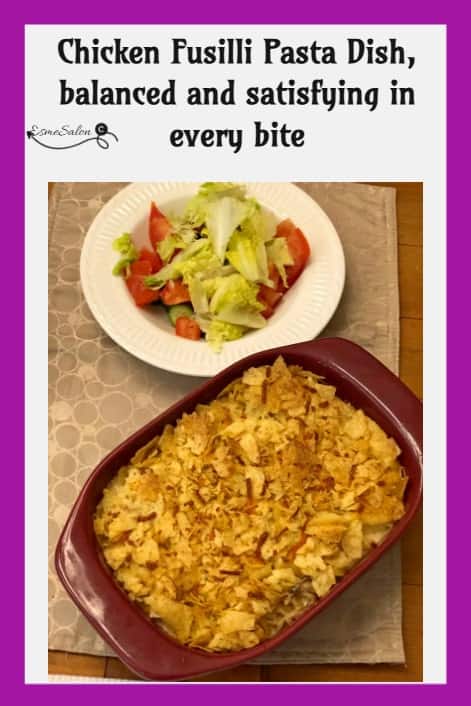 an image of a Chicken Fusilli Pasta Dish with crushed chips as topping and a side of salad