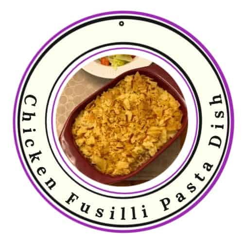 an image of a Chicken Fusilli Pasta Dish with crushed chips as topping and a side of salad